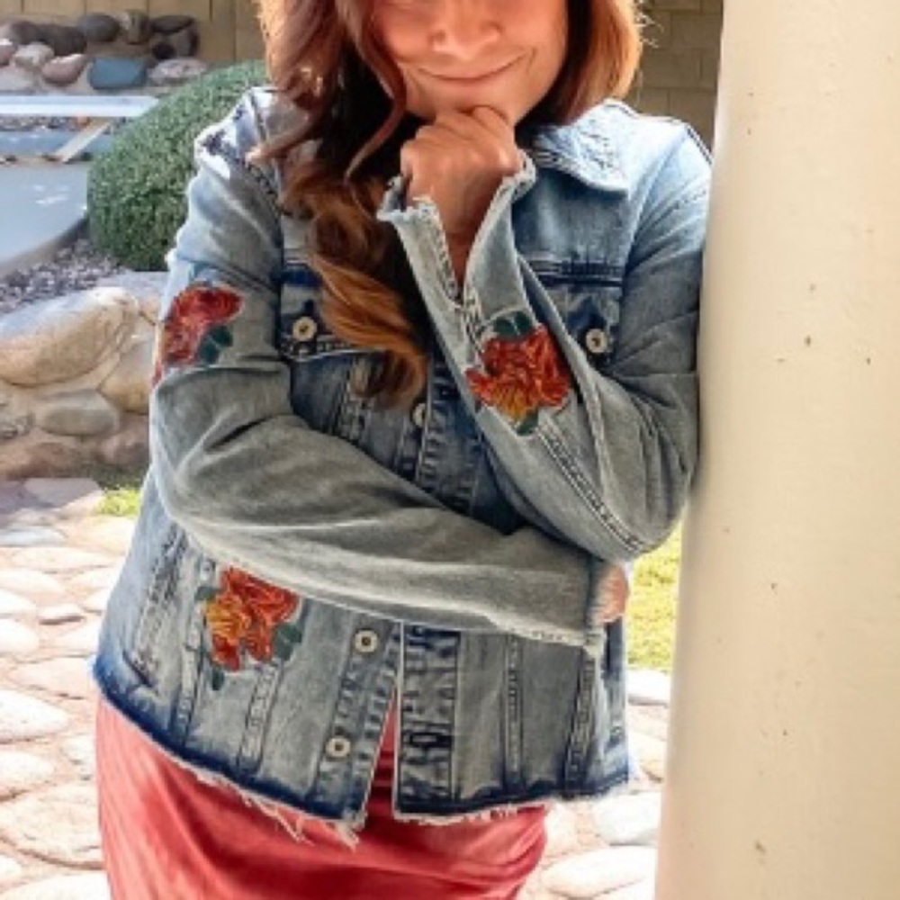 Floral embroidered color button down denim jacket with chest and inside pockets.